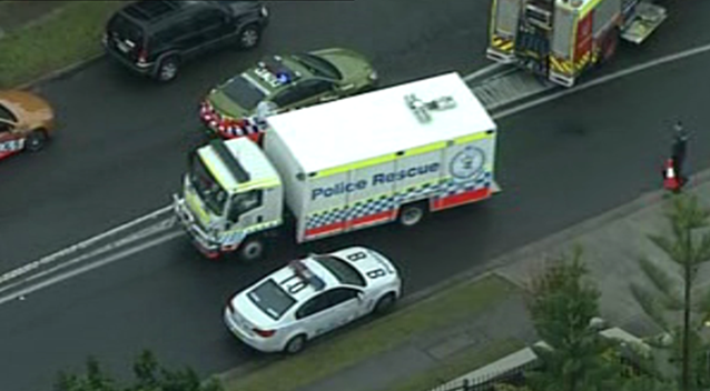 Police arrived at the scene after reports a man was barricaded in a garage. Source: 7 News