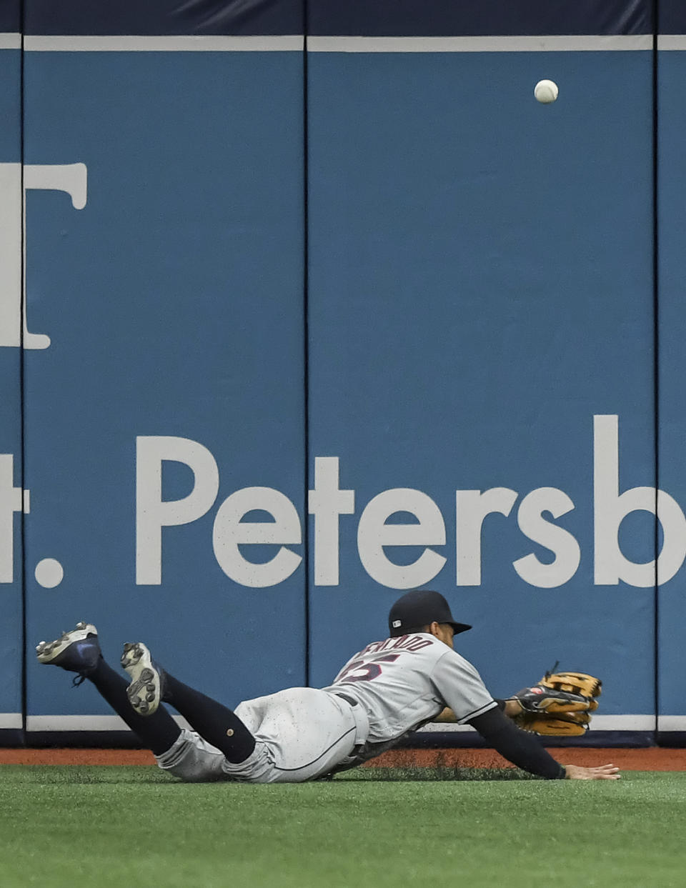 The ball bounces past Cleveland Indians left fielder Oscar Mercado as he dives for a double hit by Tampa Bay Rays' Francisco Mejia during the second inning in the second baseball game of a doubleheader Wednesday, July 7, 2021, in St. Petersburg, Fla.(AP Photo/Steve Nesius)