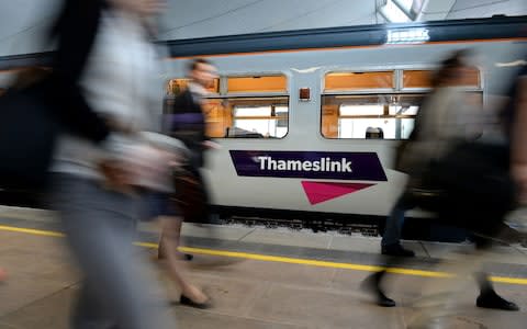 Commuters passing a Thameslink train - Credit:  Andrew Matthews/PA