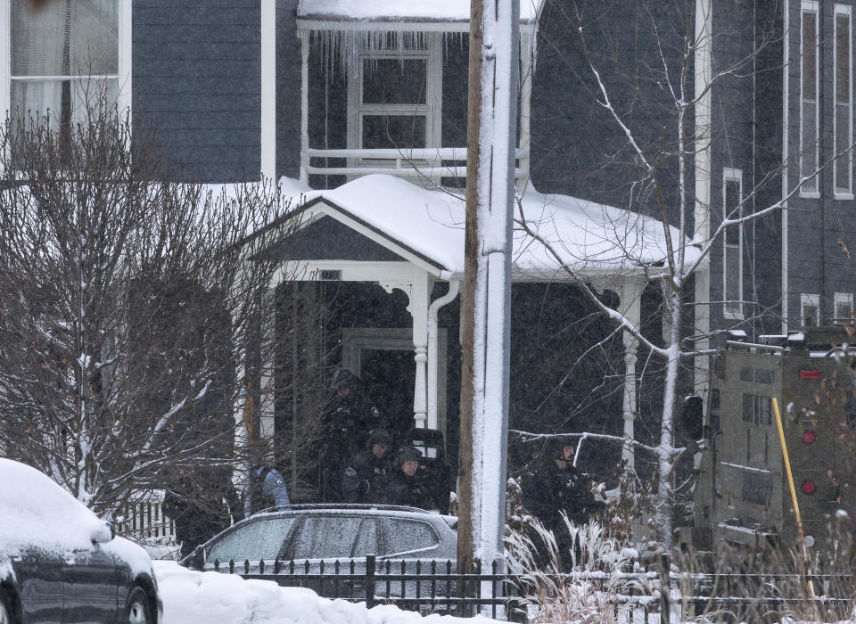 Police leave a home after breaching it on Oakland Avenue South, Sunday, Dec. 1, 2019, in Minneapolis. Two boys were found shot late Sunday morning outside the residence, where two adults were found dead later in the day. The two boys were also later pronounced dead, in what police are calling a "domestic related incident." (Kevin Martin/Star Tribune via AP)