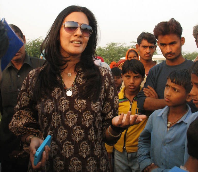 Chhavi Rajawat talks to villagers in Soda, a remote village in India's Rajasthan on November 19, 2012. The MBA graduate ditched her corporate career to become sarpanch and has been working ever since to bring better water, solar power, paved roads, toilets and a bank to her ancestral village