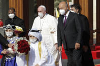 Pope Francis is welcomed by Iraqi President Barham Salih, at Baghdad's Presidential Palace, Iraq, Friday, March 5, 2021. Pope Francis has arrived in Iraq to urge the country's dwindling number of Christians to stay put and help rebuild the country after years of war and persecution, brushing aside the coronavirus pandemic and security concerns. (AP Photo/Andrew Medichini)