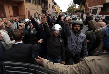 Supporters of Nazi war criminal Erich Priebke shout slogans after the hearse carrying his coffin arrived in Albano Laziale near Rome October 15, 2013. REUTERS/Yara Nardi