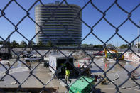 FILE - Workers pump water out of the foundation of the former Champlain Towers South building, Thursday, May 12, 2022, in Surfside, Fla. Attorneys for the families who lost relatives or homes in last year’s collapse of a Florida condominium tower that killed 98 people finalized a $1 billion settlement on Friday, May 27, 2022. (AP Photo/Marta Lavandier, File)