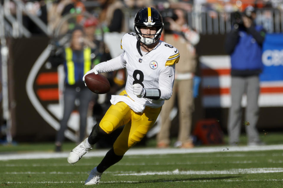 Pittsburgh Steelers quarterback Kenny Pickett (8) runs out of the pocket against the Cleveland Browns during the first half of an NFL football game, Sunday, Nov. 19, 2023, in Cleveland. (AP Photo/Ron Schwane)