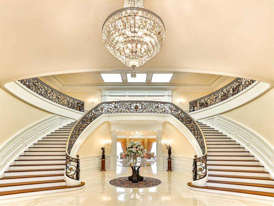 A glorious double stair case greets you when you walk in. It's perfect for races upstairs. (Zoocasa)