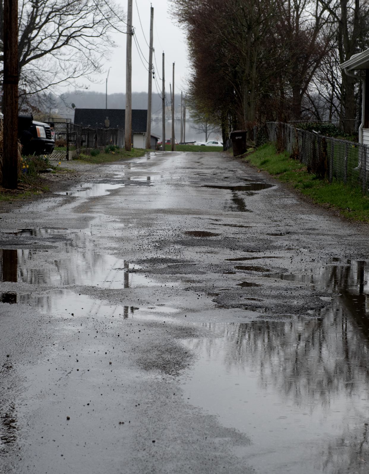 Rainwater fills up potholes fanning out across Utica Avenue on Wednesday in Springfield Township. A recently defeated renewal levy has put the township's road repair program in jeopardy.