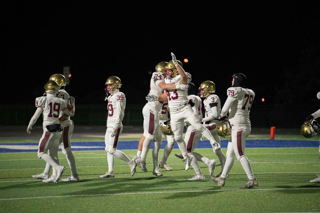 Watterson's Zack Weber (24) and Layne Peters (43) celebrate the Eagles' 27-14 win over Celina in a Division III state semifinal Friday at Doug Adams Stadium in Xenia.