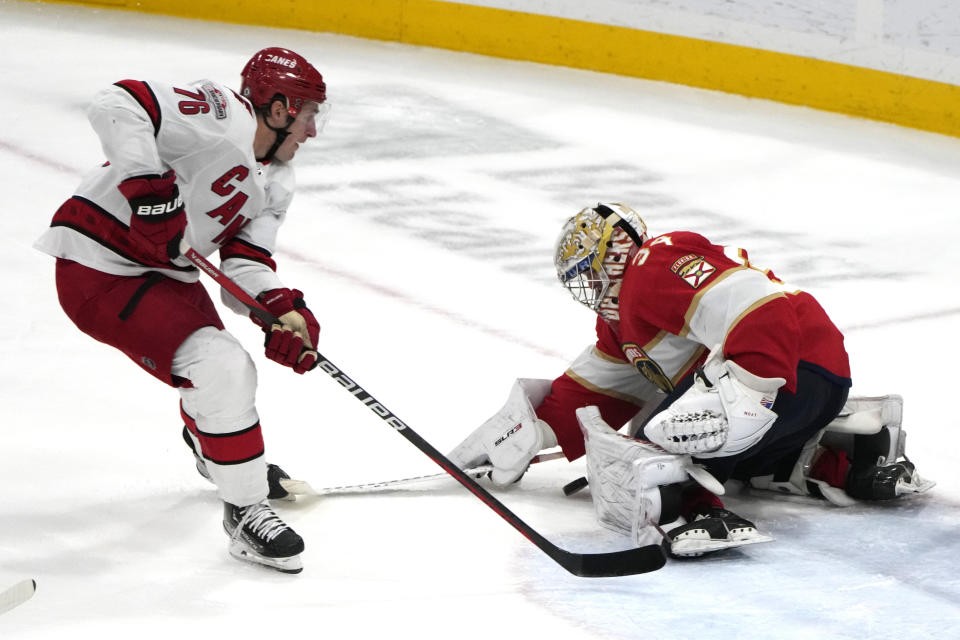 Florida Panthers goaltender Alex Lyon (34) stops a shot by Carolina Hurricanes defenseman Brady Skjei (76) during the third period of an NHL hockey game, Thursday, April 13, 2023, in Sunrise, Fla. (AP Photo/Lynne Sladky)