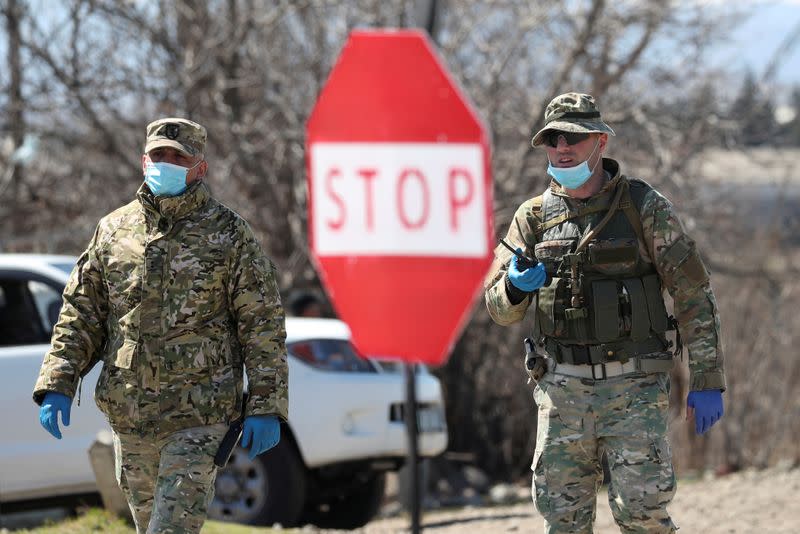 FILE PHOTO: Georgian servicemen stand guard at a check point in Marneuli