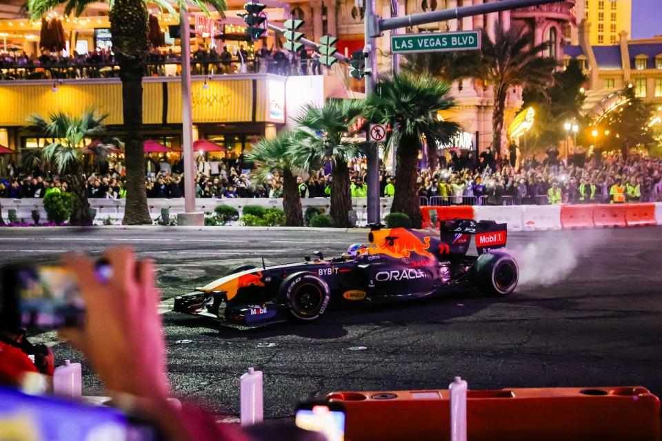 A Red Bull F1 car does burnouts on the Las Vegas Strip.