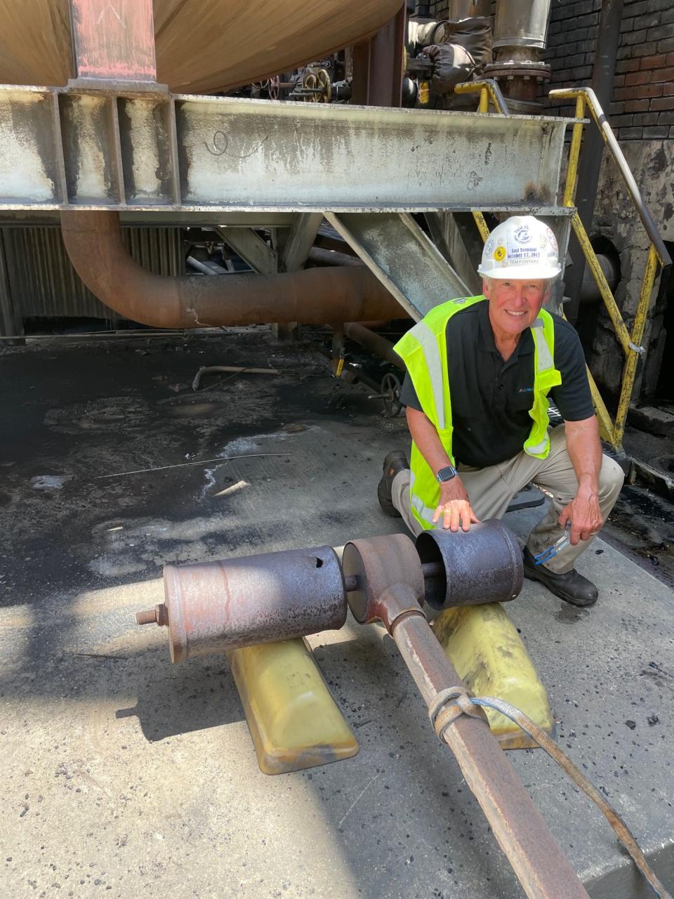 Tem Fontaine sits with the paper mill's iconic whistle after it was removed by millwrights on June 8. The whistle will be headed to the Bay County Historical Museum on Harrison Avenue.