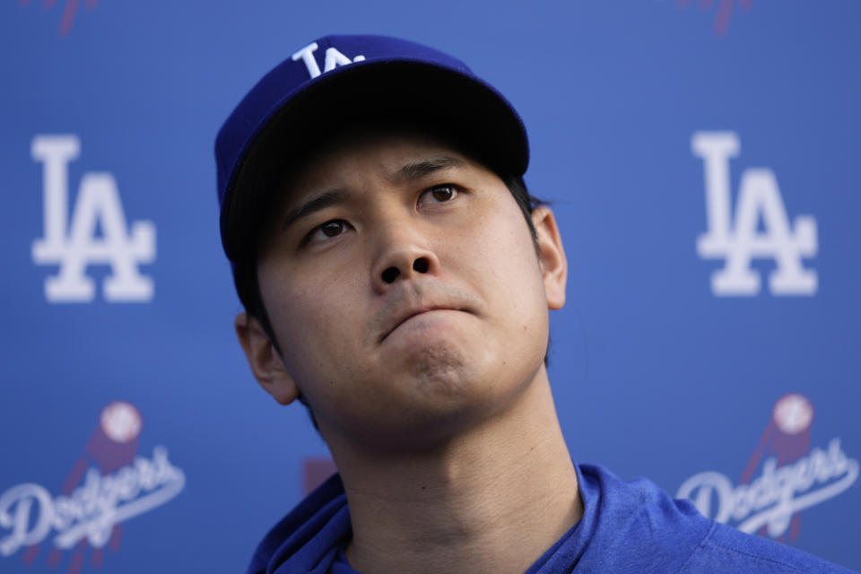 Los Angeles Dodgers' Shohei Ohtani pauses as he speaks to media at Camelback Ranch in Phoenix, Friday, Feb. 9, 2024, on the first day of spring training baseball workouts for the Dodgers. (AP Photo/Carolyn Kaster)