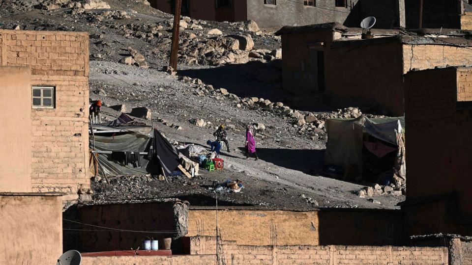 PHOTO: People gather their belongings under a tent after recovering it from the rubble of their home in the mountain village of Moulay Brahim in the central province of al-Haouz, on Sept. 11, 2023. (Philippe Lopez/AFP via Getty Images)