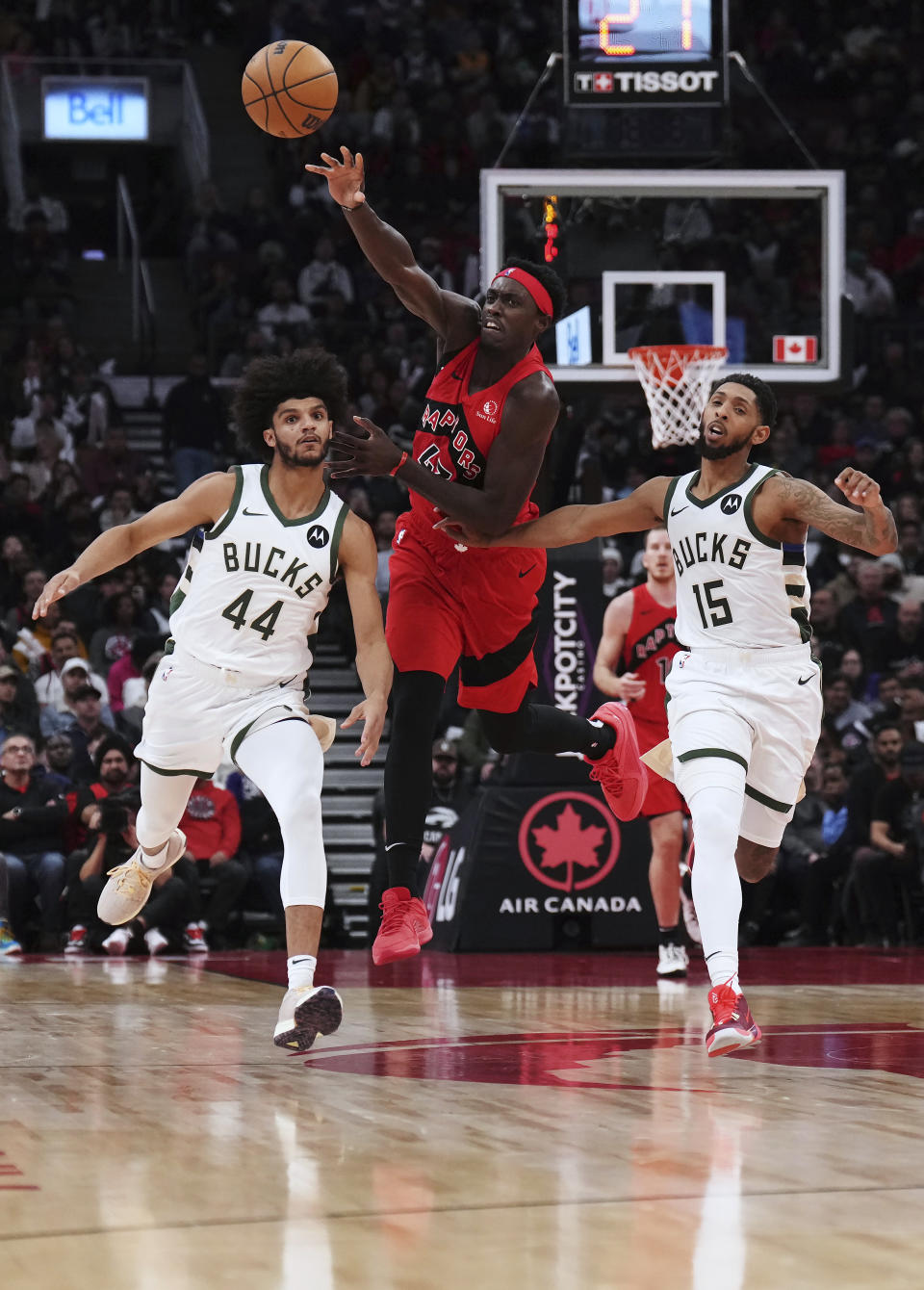 Toronto Raptors forward Pascal Siakam (43) passes the ball as Milwaukee Bucks guard Andre Jackson Jr. (44) and guard Cameron Payne (15) watch during the second half of an NBA basketball game Wednesday, Nov. 1, 2023, in Toronto. (Nathan Denette/The Canadian Press via AP)