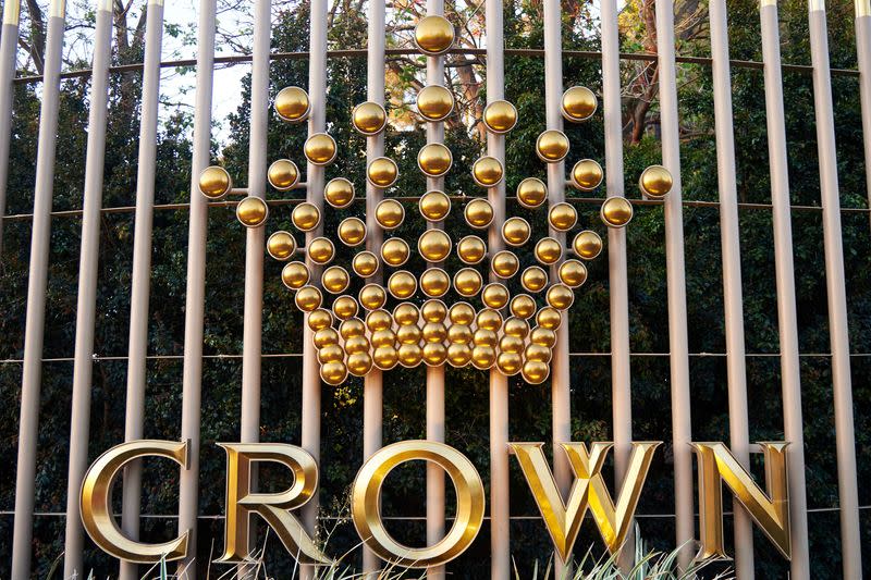 FILE PHOTO: The logo of Australia's top casino operator Crown Resorts adorns a fence surrounding the Crown Perth hotel and casino complex in Western Australia