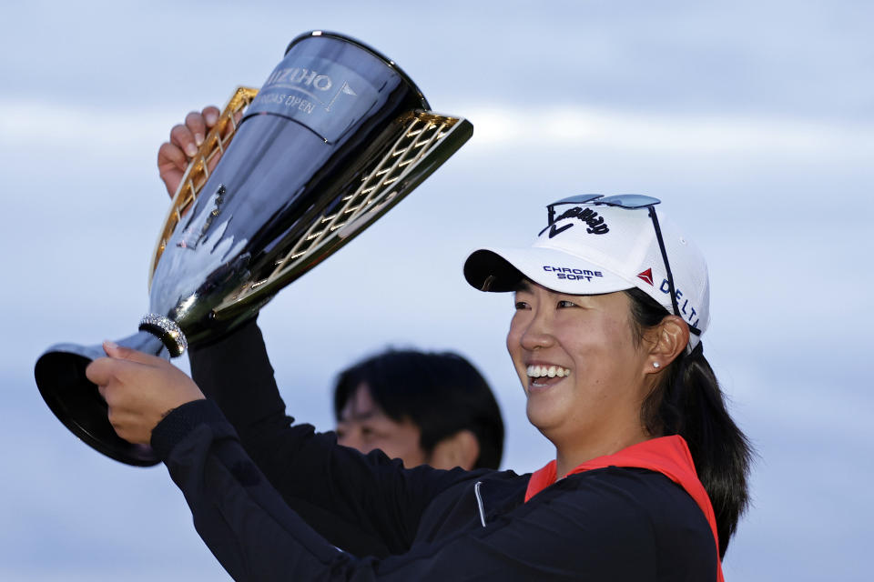 Rose Zhang holds up the trophy after winning the Mizuho Americas Open golf tournament, Sunday, June 4, 2023, in Jersey City, N.J. (AP Photo/Adam Hunger)