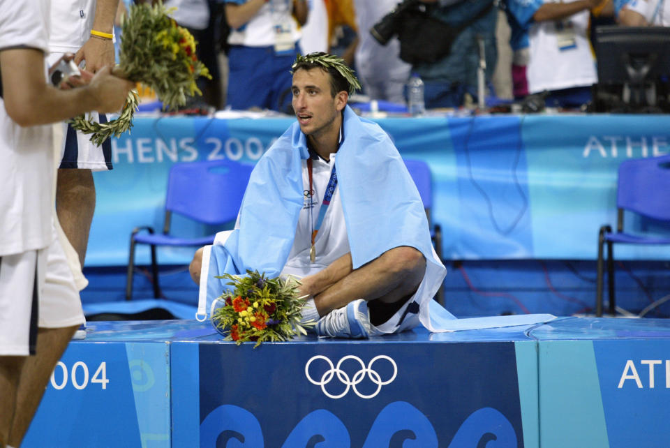 Manu Ginobili sits on the podium after doing the unthinkable: leading the Argentinian men’s national basketball team to gold at the 2004 Summer Olympics in Athens, Greece. (Getty)