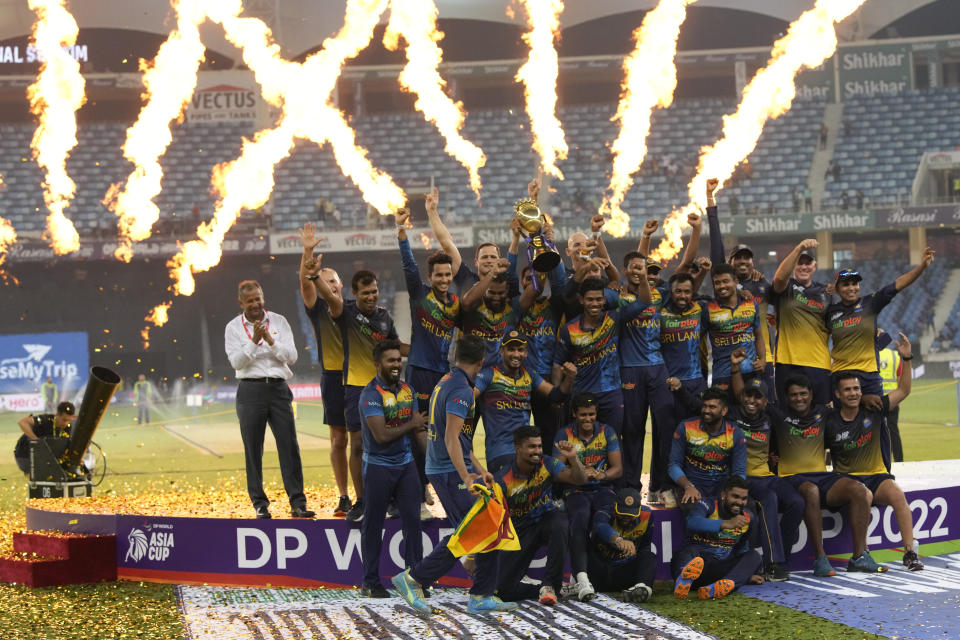 Sri Lankan players celebrate with the winners trophy after their win in the T20 cricket Asia Cup final match against Pakistan, in Dubai, United Arab Emirates, Sunday, Sept. 11, 2022. (AP Photo/Anjum Naveed)