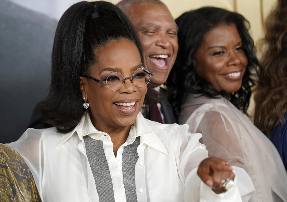 Oprah Winfrey, left, a producer of "Sidney," gestures to a photographer alongside the film's director Reginald Hudlin, center, and Sidney Poitier's daughter Sherri at the premiere of the documentary film, Wednesday, Sept. 21, 2022, at the Academy Museum of Motion Pictures in Los Angeles. (AP Photo/Chris Pizzello)
