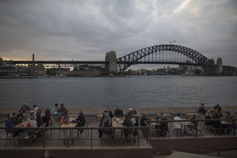 Diners at a restaurant near Sydney Harbour Bridge on Saturday, May 27, 2023.  Photographer: Brent Lewin/Bloomberg