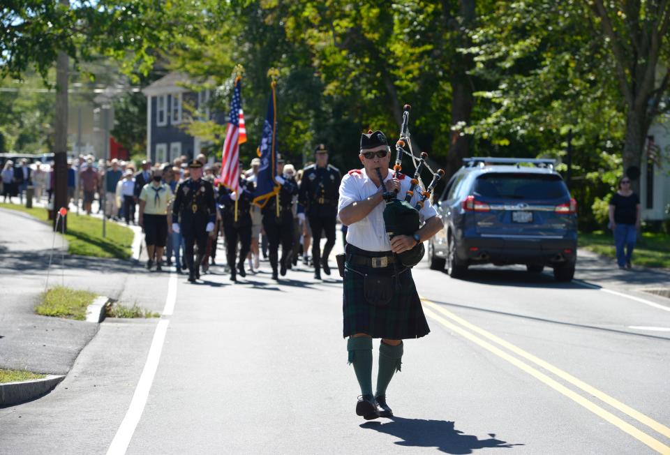 Dave Knauer leads the procession down Main Street from the Barnstable Fire Department to St. Mary's Episcopal Church during the 2021 annual ceremony and service of remembrance sponsored by the fire department and the church.