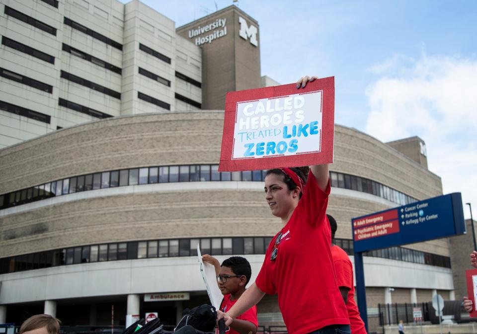 Michigan Medicine nurses and supporters march around the hospital buildings during a UMPNC informational picket for safe patient care and fair contract at Fuller Park in Ann Arbor on July 16, 2022.