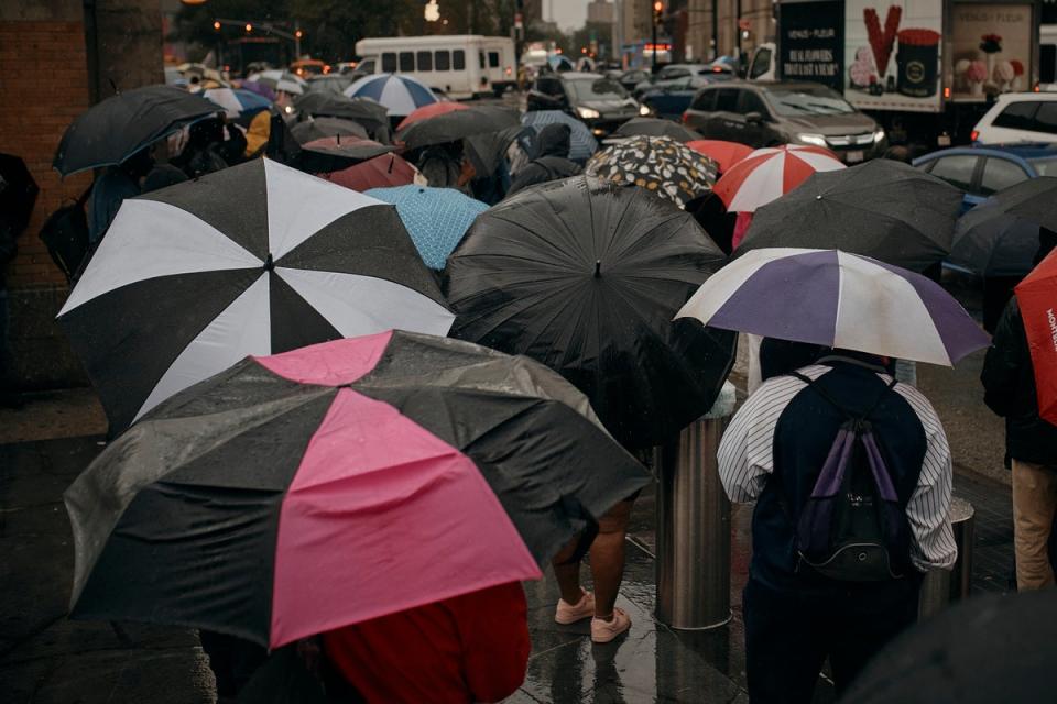 People wait for the bus as trains get cancelled due to flooding from heavy rains. The governor specifically thanked bus drivers on Saturday for helping to keep the city moving (Copyright 2023 The Associated Press. All rights reserved.)