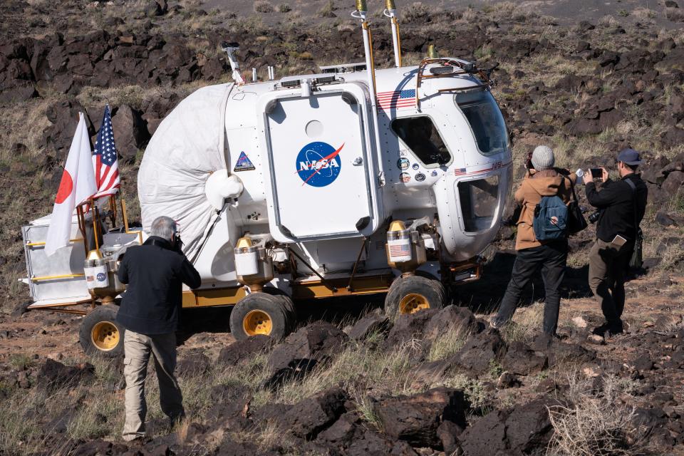 Attendees photograph the Artemis Rover during a press briefing on Oct. 24, 2022, at NASA's Desert Research and Technology Studies (Deserts RATS) Artemis' Rover Mission Simulations site at Black Point Lava Flow, located 40 miles north of Flagstaff.