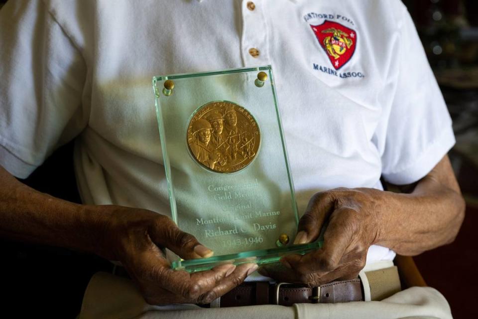 Rich Davis, 97, holds his Congressional Gold Medal Wednesday as one of the last surviving Montford Point Marines, a Black World War II unit. Paul Kitagaki Jr./pkitagaki@sacbee.com