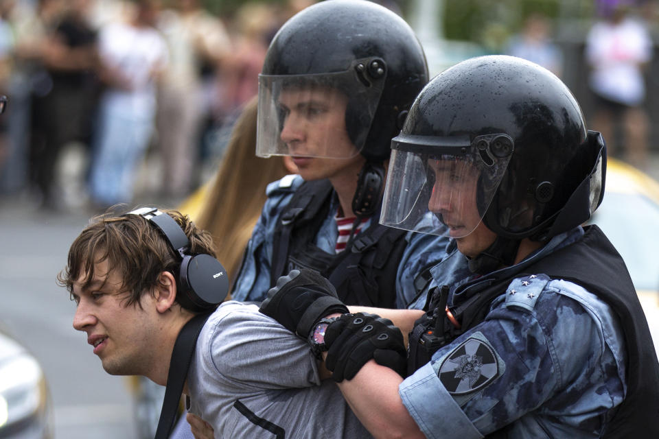 Police officers detain a protester during a march in Moscow, Russia, Wednesday, June 12, 2019. Police and hundreds of demonstrators are facing off in central Moscow at an unauthorized march against police abuse in the wake of the high-profile detention of a Russian journalist. More than 20 demonstrators have been detained, according to monitoring group. (AP Photo/Alexander Zemlianichenko)