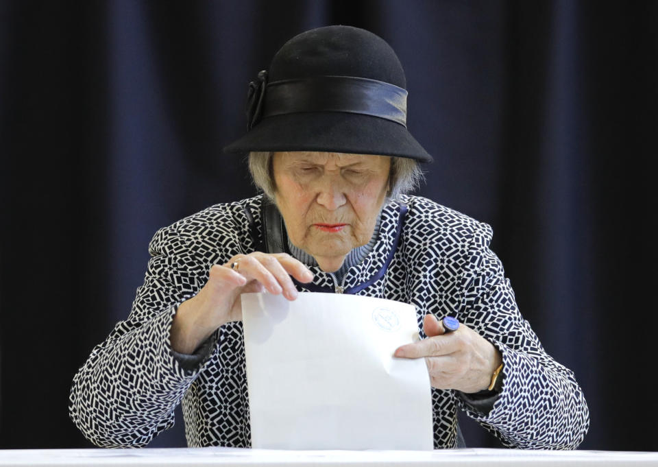 A woman casts her vote in Bucharest, Romania, Sunday, Nov. 10, 2019. Voting got underway in Romania's presidential election after a lackluster campaign overshadowed by a political crisis which saw a minority government installed just a few days ago. (AP Photo/Vadim Ghirda)