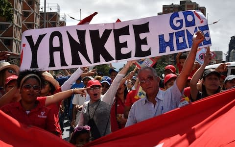 Supporters of Venezuelan President Nicolas Maduro take part in a march in Caracas, - Credit: AFP