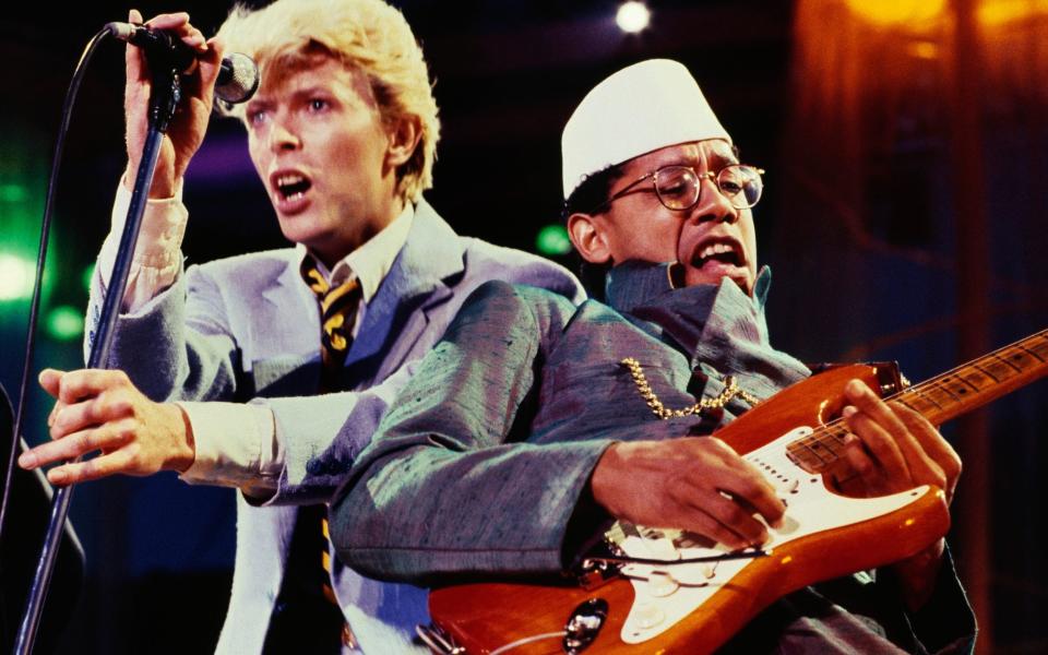 Bowie performs alongside his guitarist Carlos Alomar in 1983 - Getty