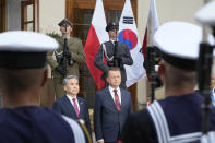 Poland's Defense Minister Mariusz Blaszczak, center right, and his counterpart from South Korea, Minister Lee Jong-Sup, center left, attend a military welcome ceremony in Warsaw, Poland, Thursday, Aug. 31, 2023 prior to talks on regional security and Poland's arms purchases from South Korea in the face of war in Poland's neighbour country Ukraine. (AP Photo/Czarek Sokolowski)