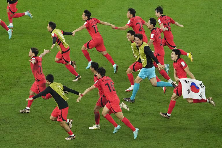 South Korea's team players celebrate after the World Cup group H soccer match between South Korea and Portugal, at the Education City Stadium in Al Rayyan, Qatar, Friday, Dec. 2, 2022. (AP Photo/Darko Bandic)