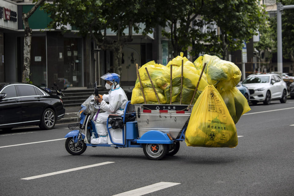 A worker collects waste during the Shanghai lockdown last month. Source: Getty