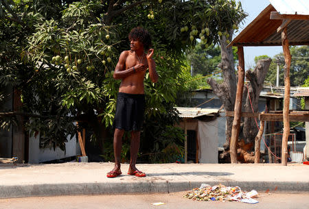 A resident waits for a bus as he stands on a footpath in the area called Poreporena Villages in the city of Port Moresby, Papua New Guinea, November 19, 2018. REUTERS/David Gray