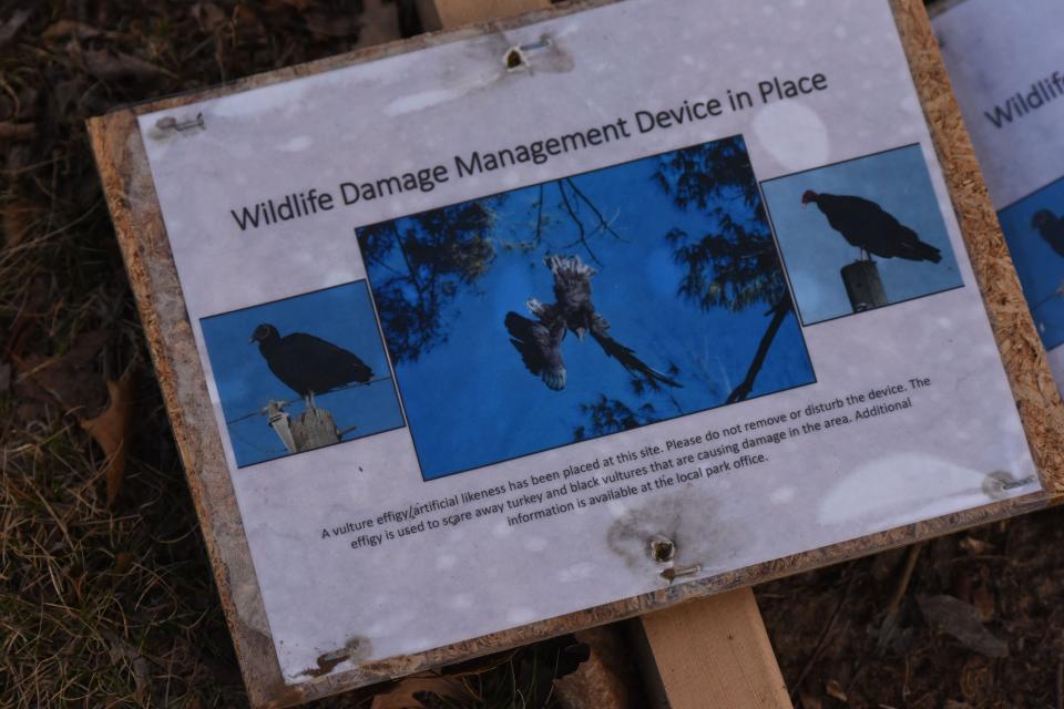 A sign explaining the vulture effigy as a Wildlife Damage Management Device is posted at Charles Mill Lake.