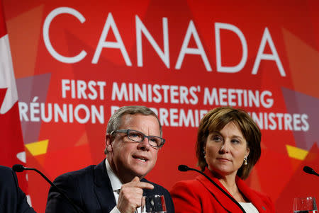 Saskatchewan Premier Brad Wall (L) speaks during the closing news conference at the First Ministers’ meeting as British Columbia Premier Christy Clark looks on in Ottawa, Ontario, Canada, December 9, 2016. REUTERS/Chris Wattie