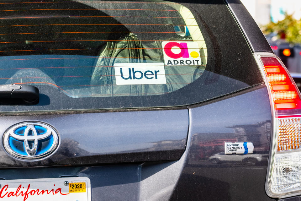Jan 18, 2020 San Francisco / CA / USA - UBER and Adroit stickers on the rear window of a Toyota Prius Hybrid vehicle offering rides in San Francisco