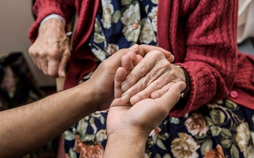 A carer and an elderly person -  Richard Bailey/Getty Images