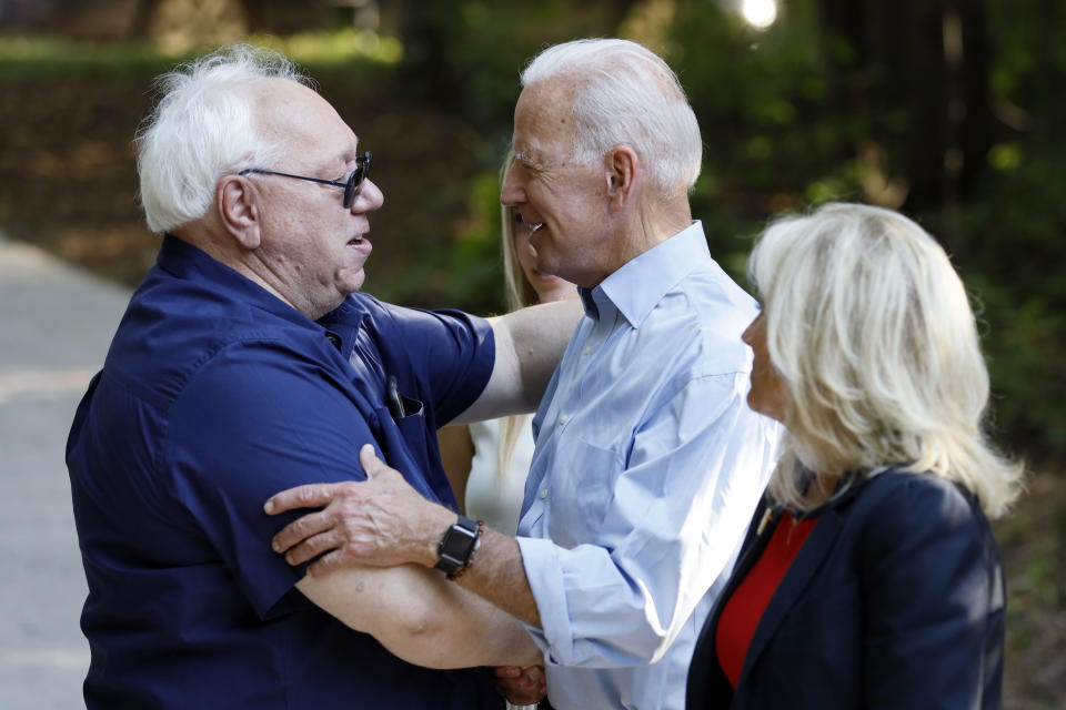 Former Vice President and Democratic presidential candidate Joe Biden greets a local resident as he arrives to speak at a house party at former Agriculture Secretary Tom Vilsack's house, Monday, July 15, 2019, in Waukee, Iowa. (AP Photo/Charlie Neibergall)