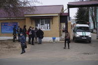 Journalists and Navalny's doctors who were prevented from seeing him at prison clinic gather in front of the penal colony where a hospital for convicts located in Vladimir, a city 180 kilometers (110 miles) east of Moscow, Russia, Tuesday, April 20, 2021. Several doctors have been prevented from seeing Russian opposition leader Alexei Navalny at a prison hospital after his three-week hunger strike. Prosecutors, meanwhile, detailed a sweeping, new case against his organization. Navalny was transferred Sunday from a penal colony east of Moscow to a prison hospital in Vladimir, east of the capital, and his lawyers and associates have said that his condition has dramatically worsened. Reports about his rapidly deteriorating health has drawn international outrage. One of his personal physicians, Dr. Anastasia Vasilyeva, led three other medical experts to try to visit Navalny, but they were denied entry after waiting for hours outside the gates. (AP Photo/Kirill Zarubin)