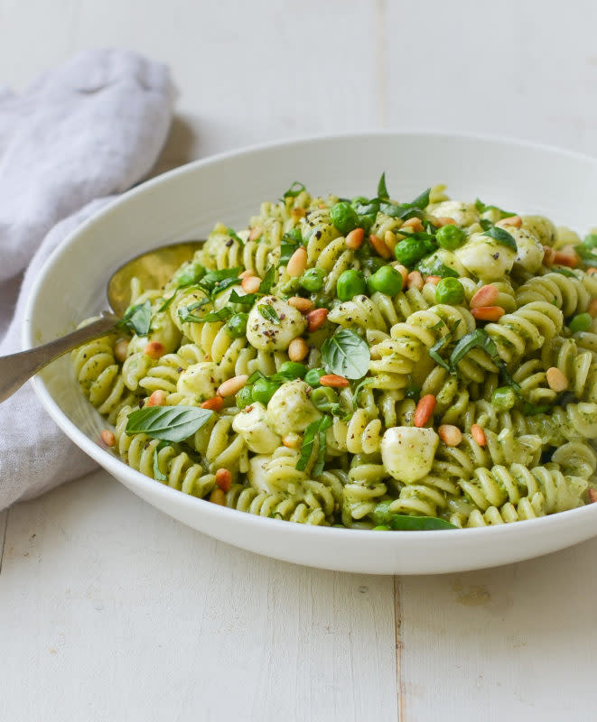 <p>Zesty pesto, green peas, pine nuts, and mozzarella pearls make a flavorful and pretty pasta salad.</p><p><strong>Get the recipe: <a href="https://www.onceuponachef.com/recipes/pasta-salad-with-pesto.html" rel="nofollow noopener" target="_blank" data-ylk="slk:Pasta Salad with Pesto;elm:context_link;itc:0;sec:content-canvas" class="link ">Pasta Salad with Pesto</a></strong></p>