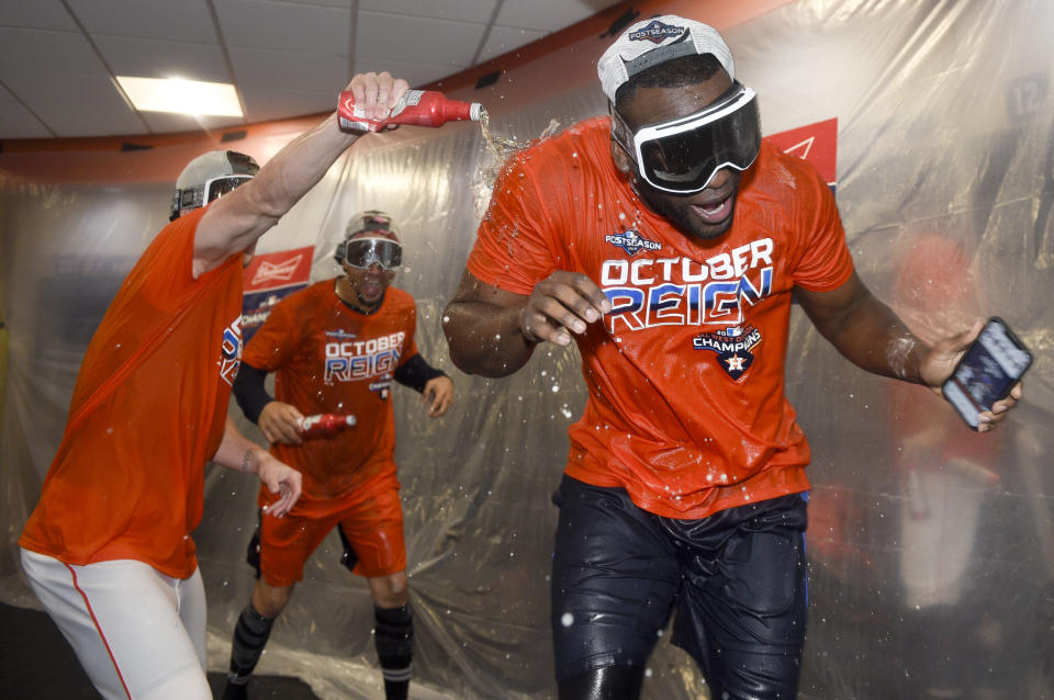 Houston Astros' Yordan Alvarez, right, celebrates the team's clinching of the AL West crown after a baseball game against the Los Angeles Angels, Sunday, Sept. 22, 2019, in Houston. (AP Photo/Eric Christian Smith)