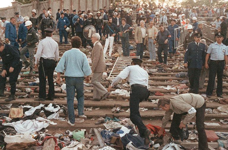 Rescuers and police search for victims at Heysel football stadium in Brussels on May 29, 1985