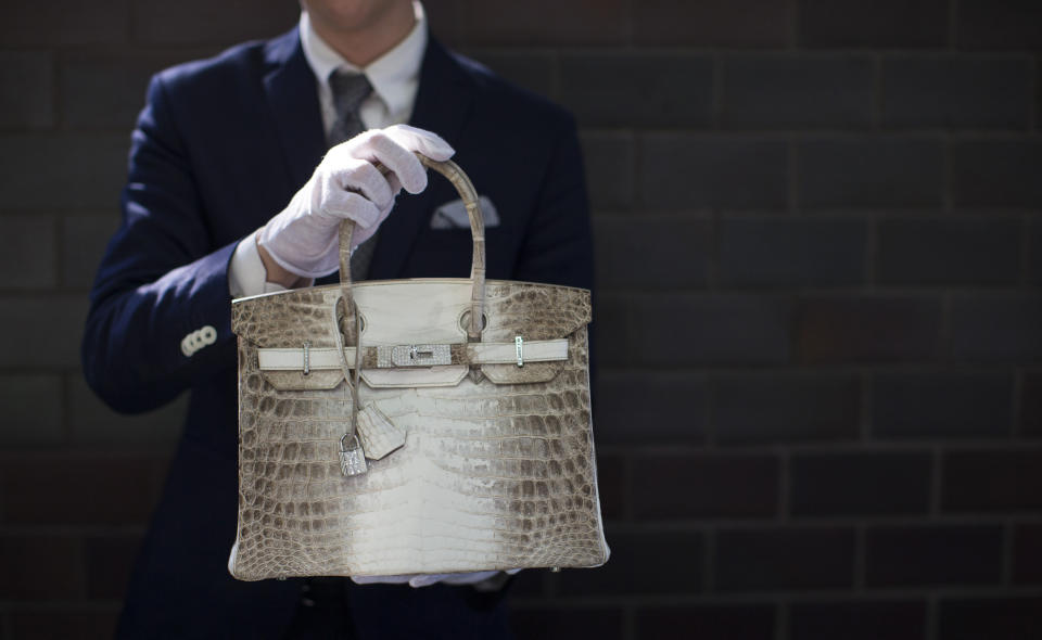 An employee holds an Hermes diamond and Himalayan Nilo Crocodile Birkin handbag at Heritage Auctions offices in Beverly Hills, CA on&nbsp;Sept. 22, 2014. The handbag has 242 diamonds with a total of 9.84 carats. (Photo: Mario Anzuoni / Reuters)