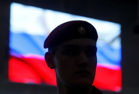 A serviceman stands in front of a screen displaying a Russian flag during a news briefing, organized by Russian defence and foreign ministries and dedicated to SSC-8/9M729 cruise missile system, at Patriot Expocentre near Moscow, Russia January 23, 2019. REUTERS/Maxim Shemetov