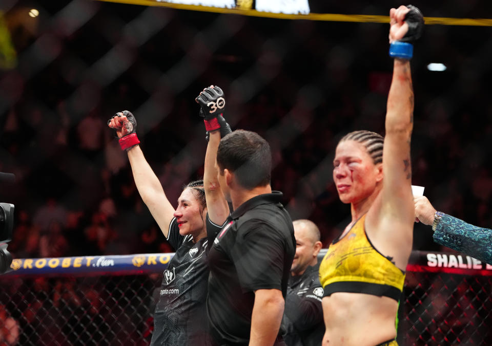 Dec 16, 2023; Las Vegas, Nevada, USA; Irene Aldana (red gloves) reacts after defeating Karol Rosa (blue gloves) during UFC 296 at T-Mobile Arena. Mandatory Credit: Stephen R. Sylvanie-USA TODAY Sports